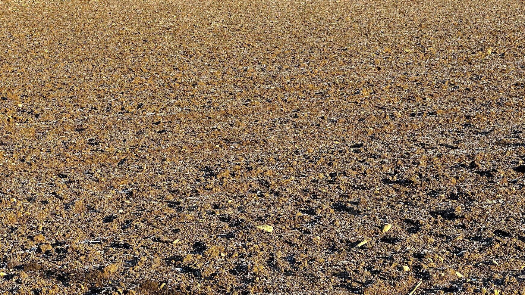 View of fields in early spring after harvest, brown plowed fields photo