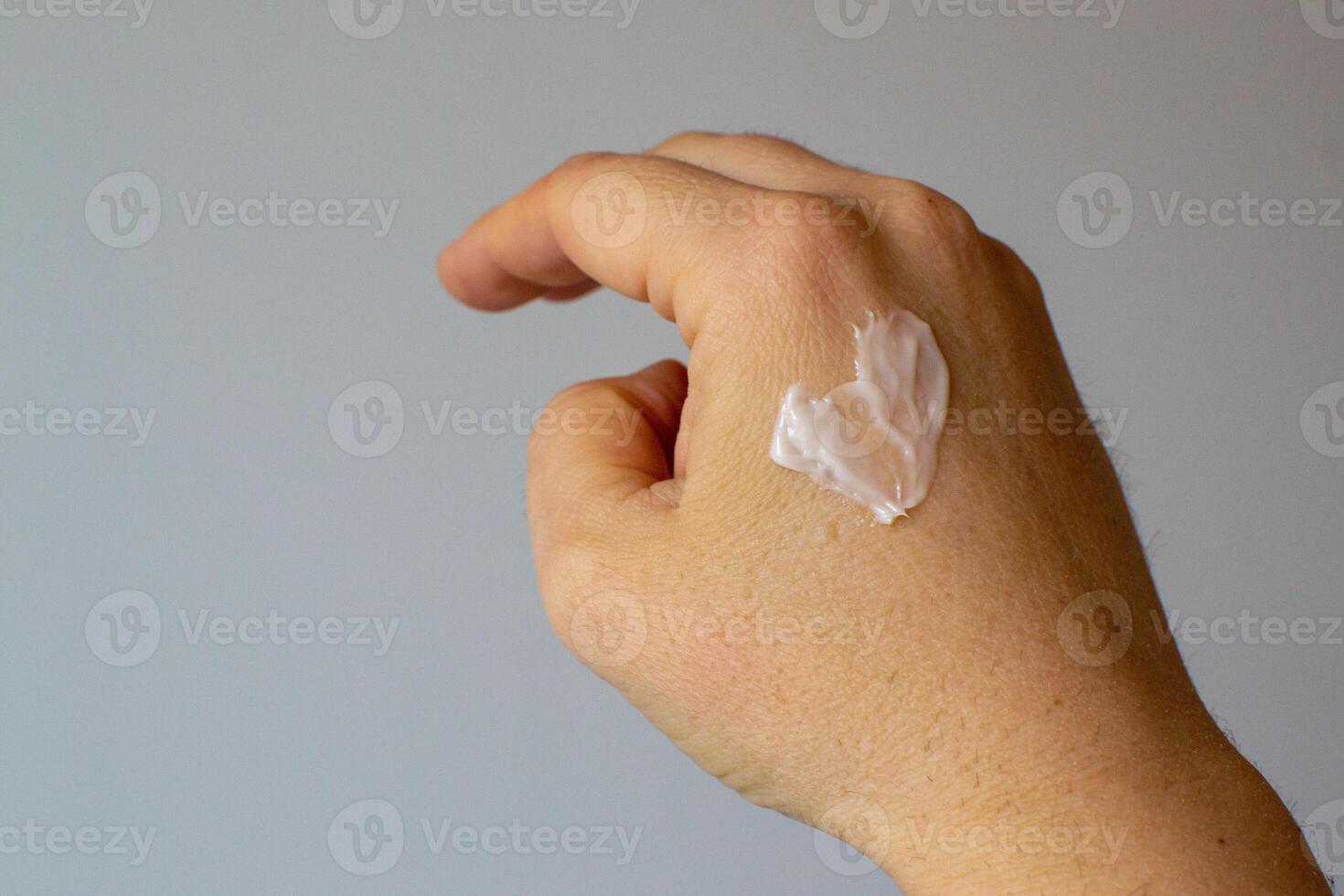 View of a cream on a female female hand in the shape of a heart photo