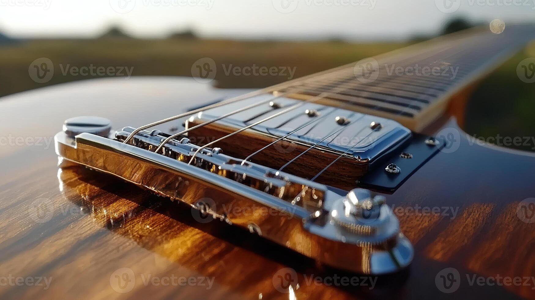 Close up of electric guitar strings and bridge with sunlit background. photo