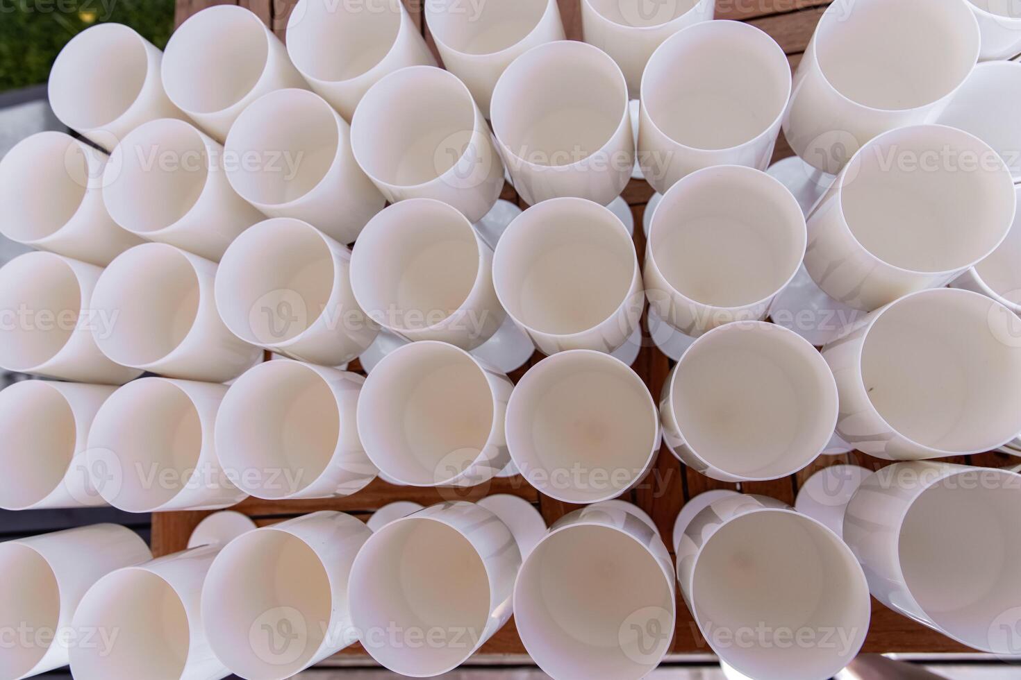 White plastic glasses for drinking wine on a table photo