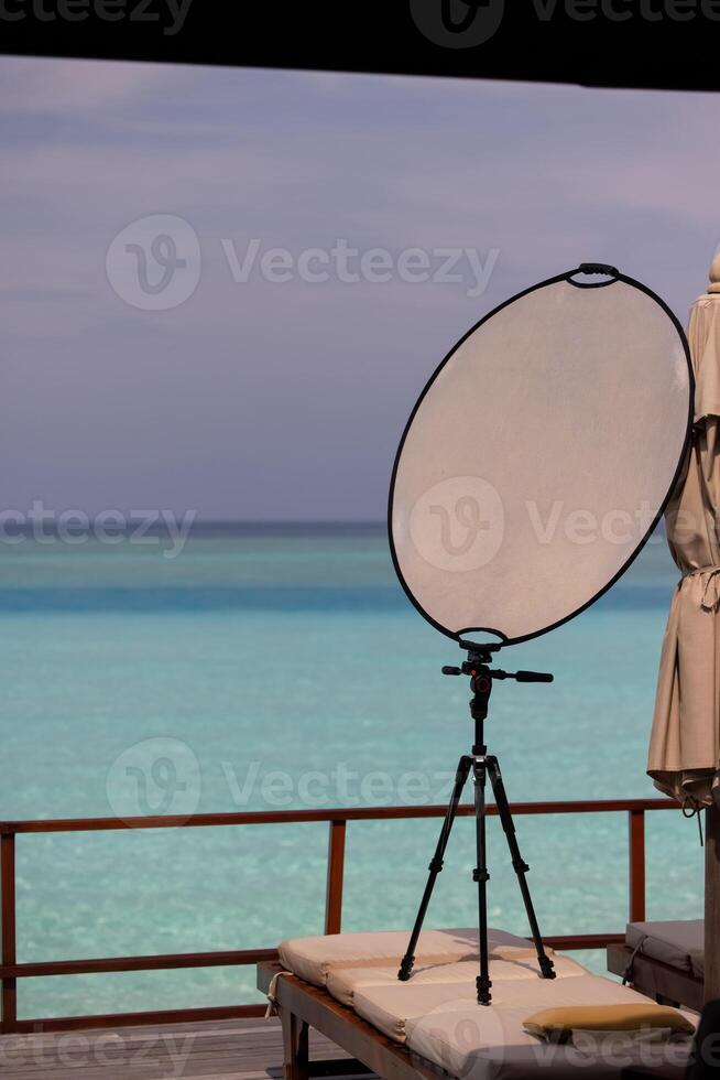 Maldives.Working with a solar reflector for photography on a tripod photo