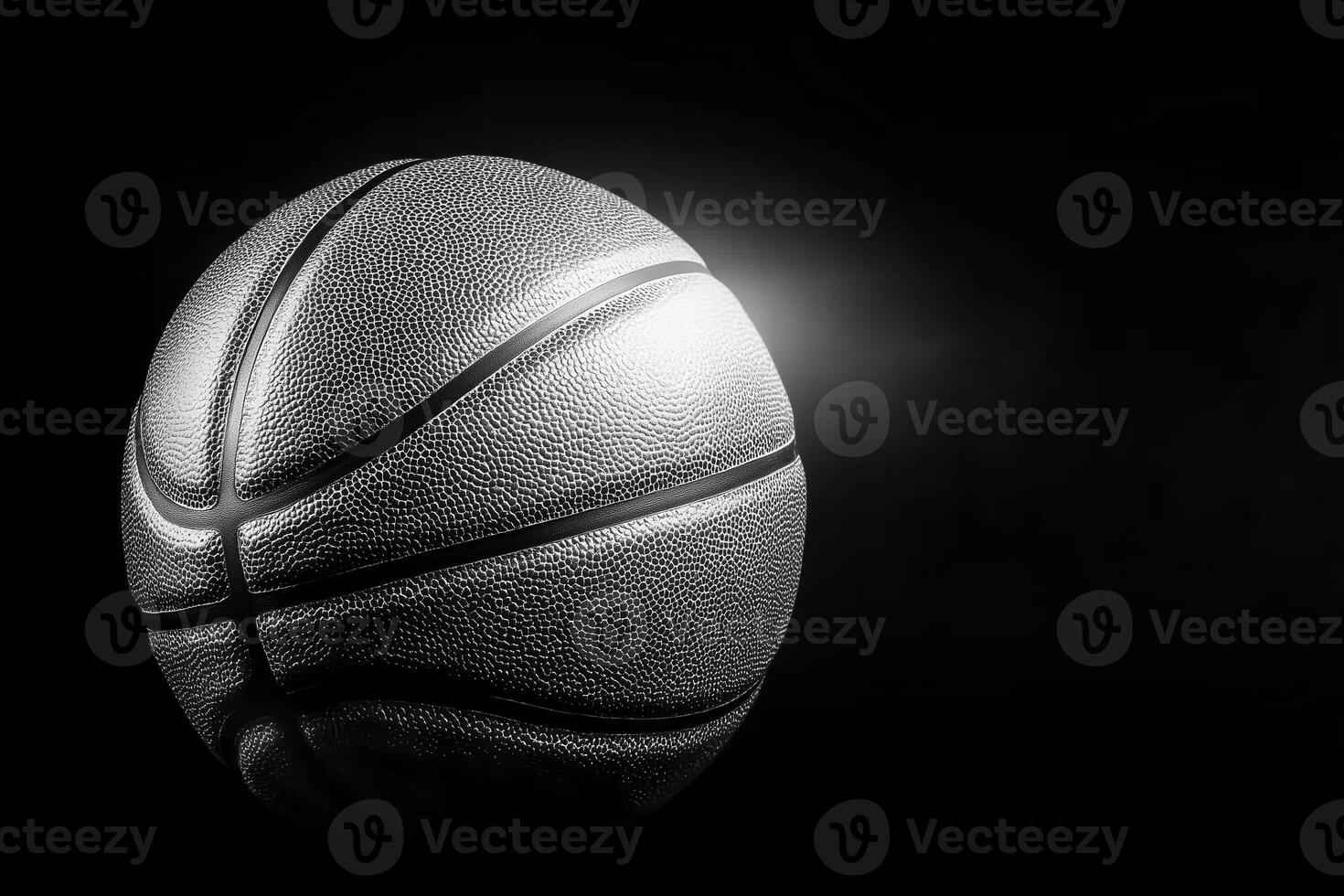 Basketball on Black Background with Dramatic Lighting for Sports Photography and Artwork photo