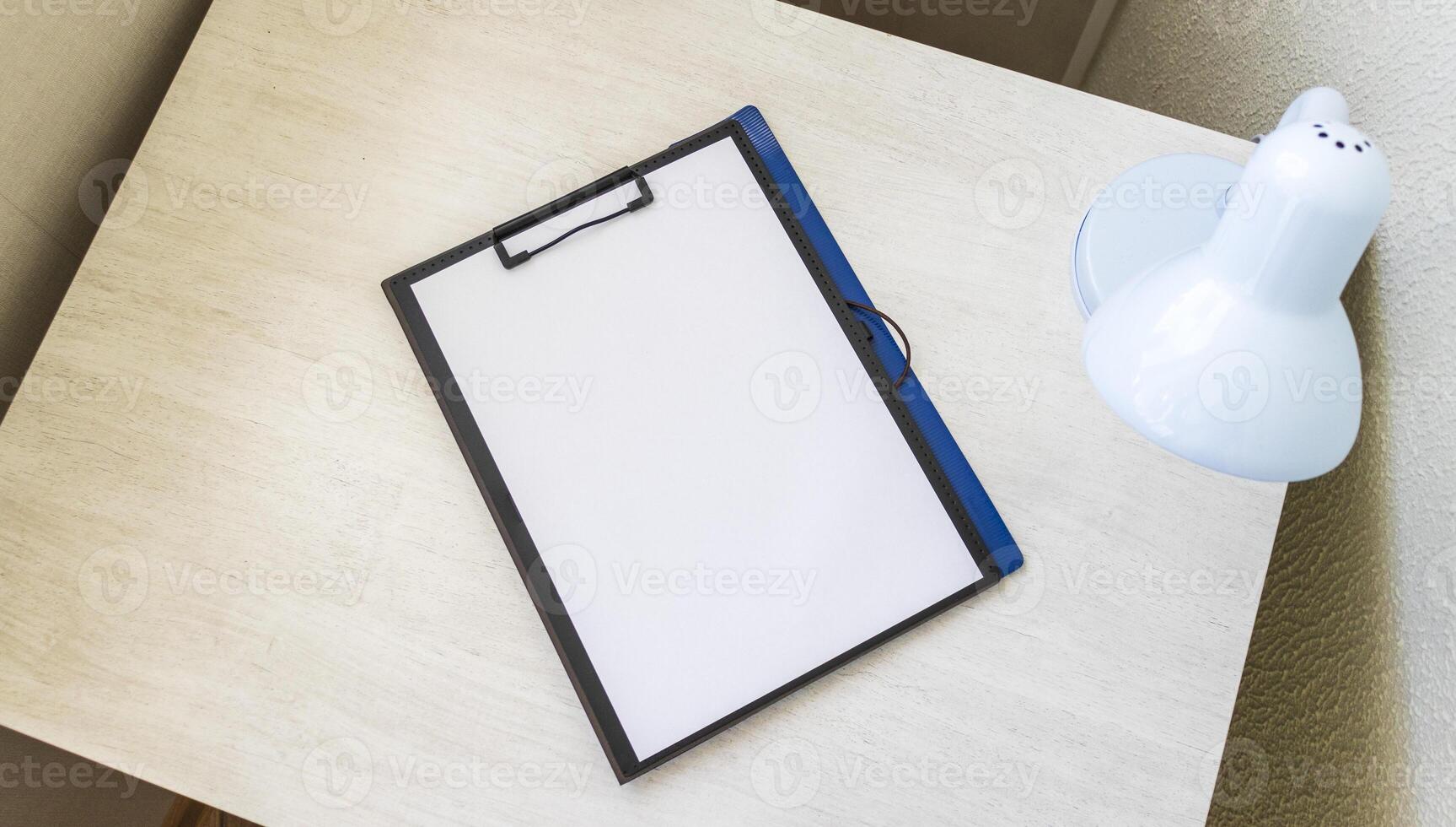 folder on the office desk with paper clip holder on the top. A4 size paper mock up. Stationary photo