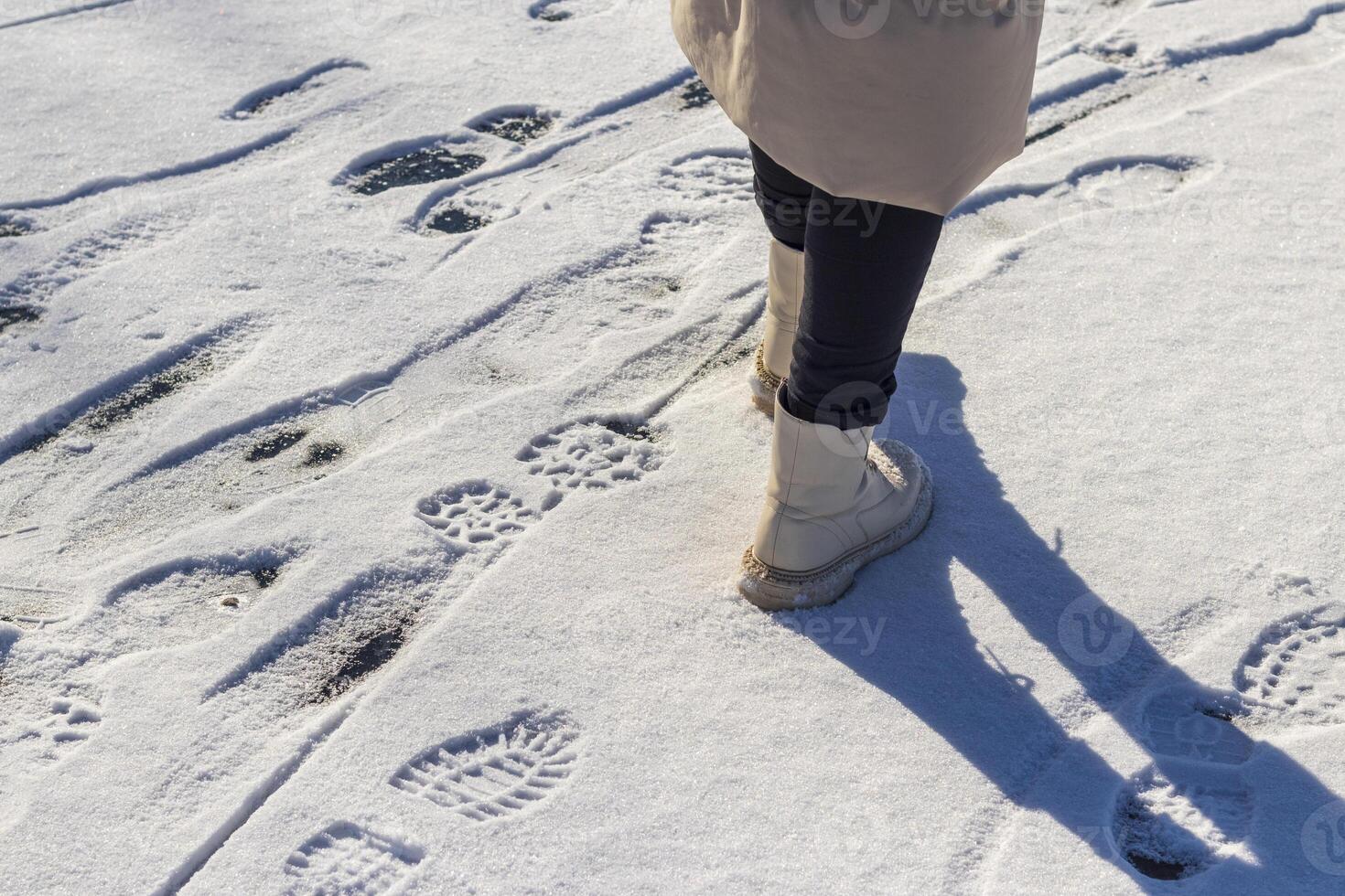 Woman walks on the snow. Concept photo