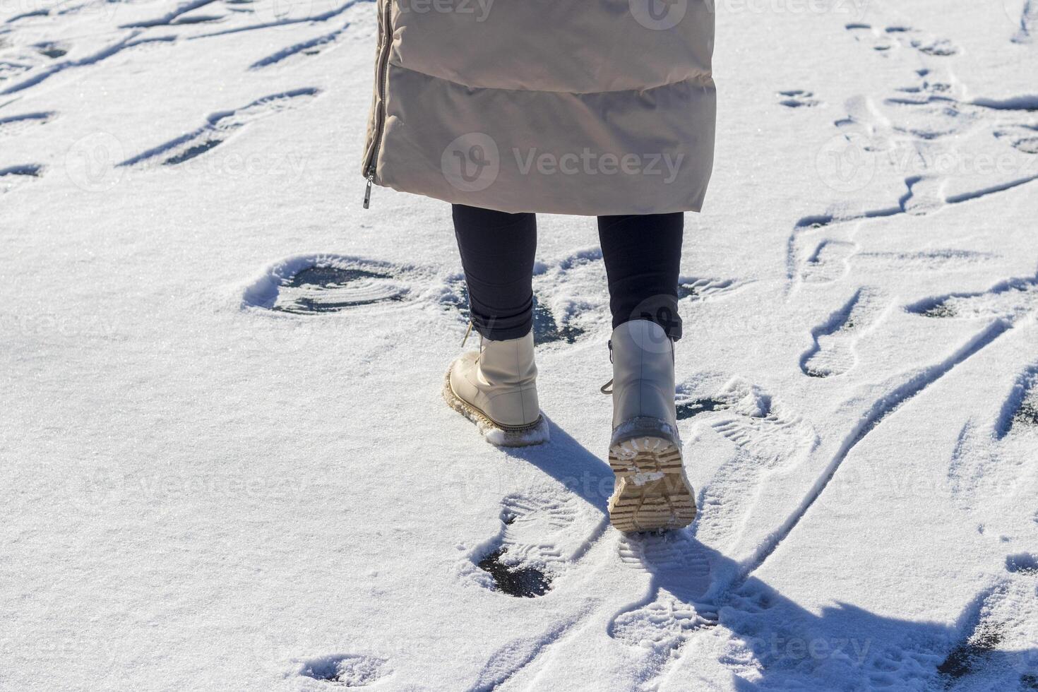 Woman walks on the snow. photo