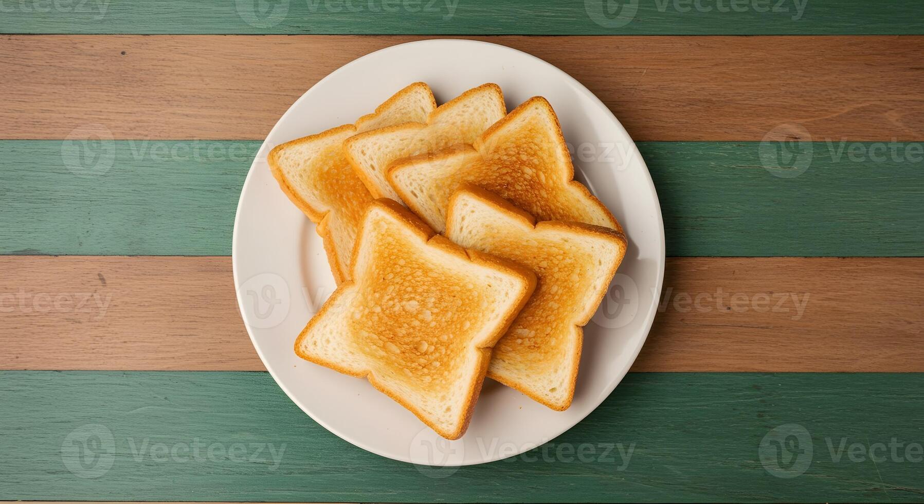 Toast on a white plate on a green and white striped table photo