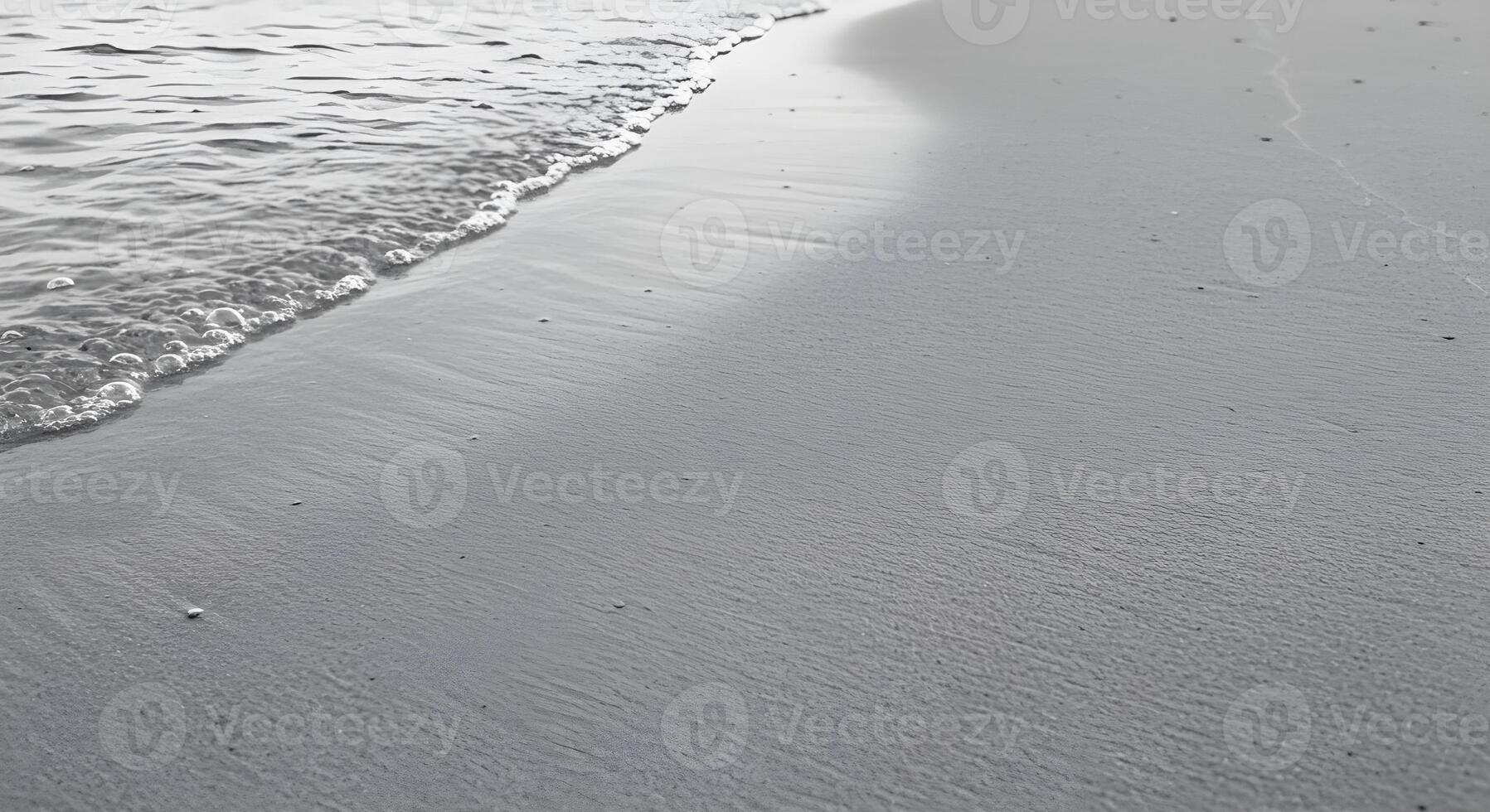 A black and white photo of a beach with waves