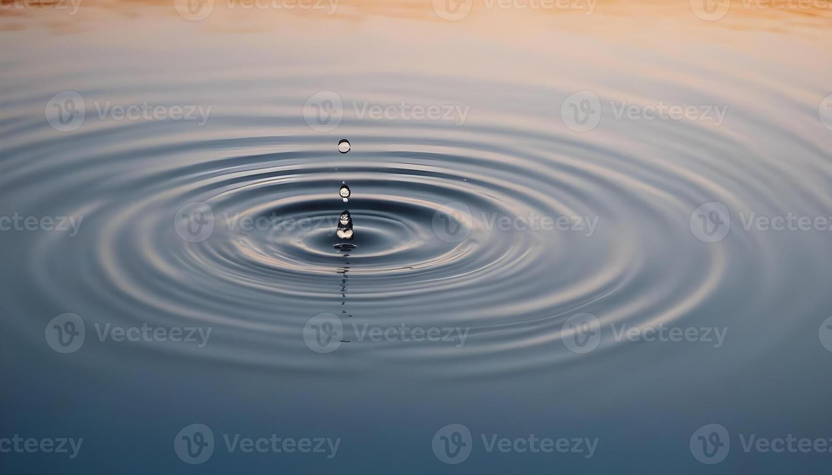 A drop of water falling into a pond photo