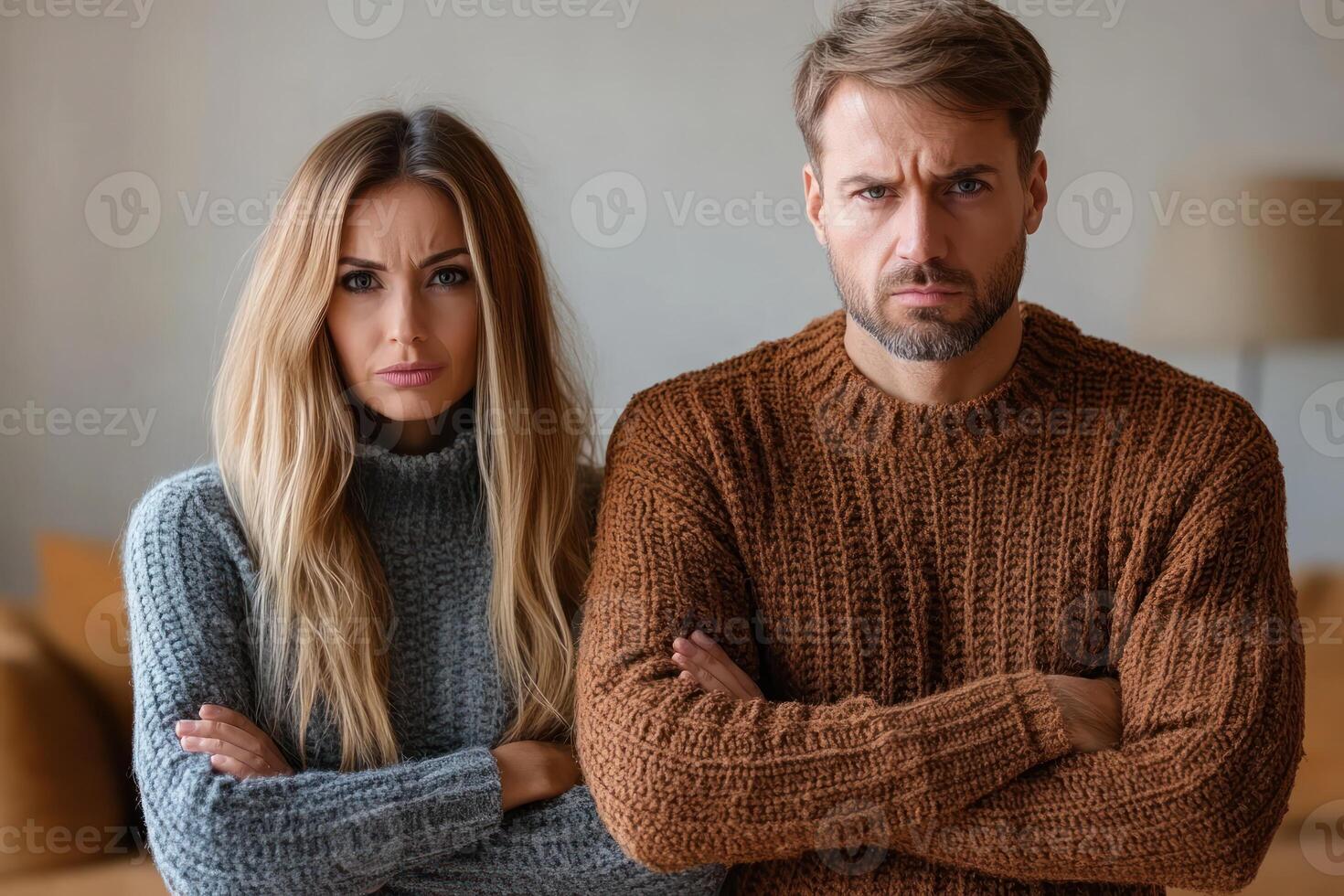 Couple with crossed arms expressing frustration indoors during a cool afternoon photo