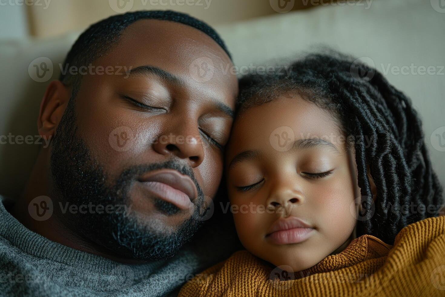 Father and daughter share a peaceful moment while napping on a couch at home in the afternoon sunlight photo