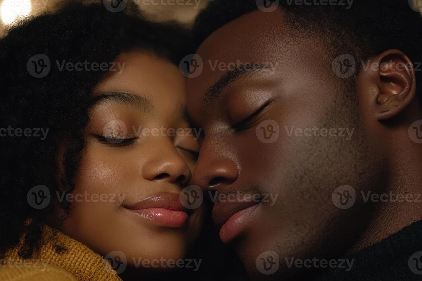 Couple sharing a tender moment in an intimate setting surrounded by soft light photo