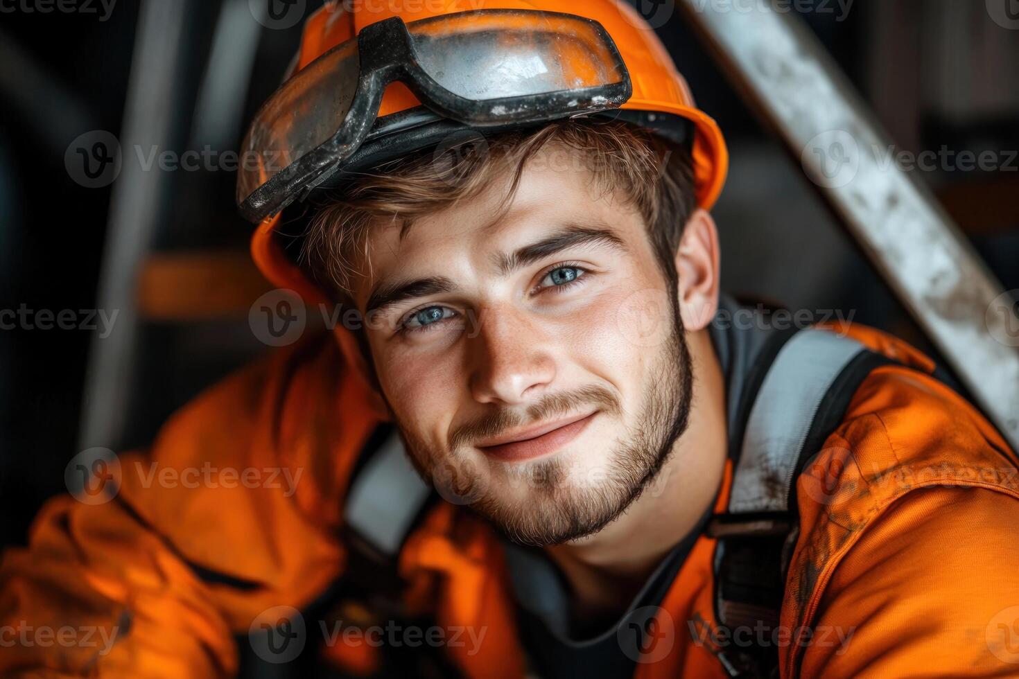 Young construction worker smiles warmly while taking a break at job site photo