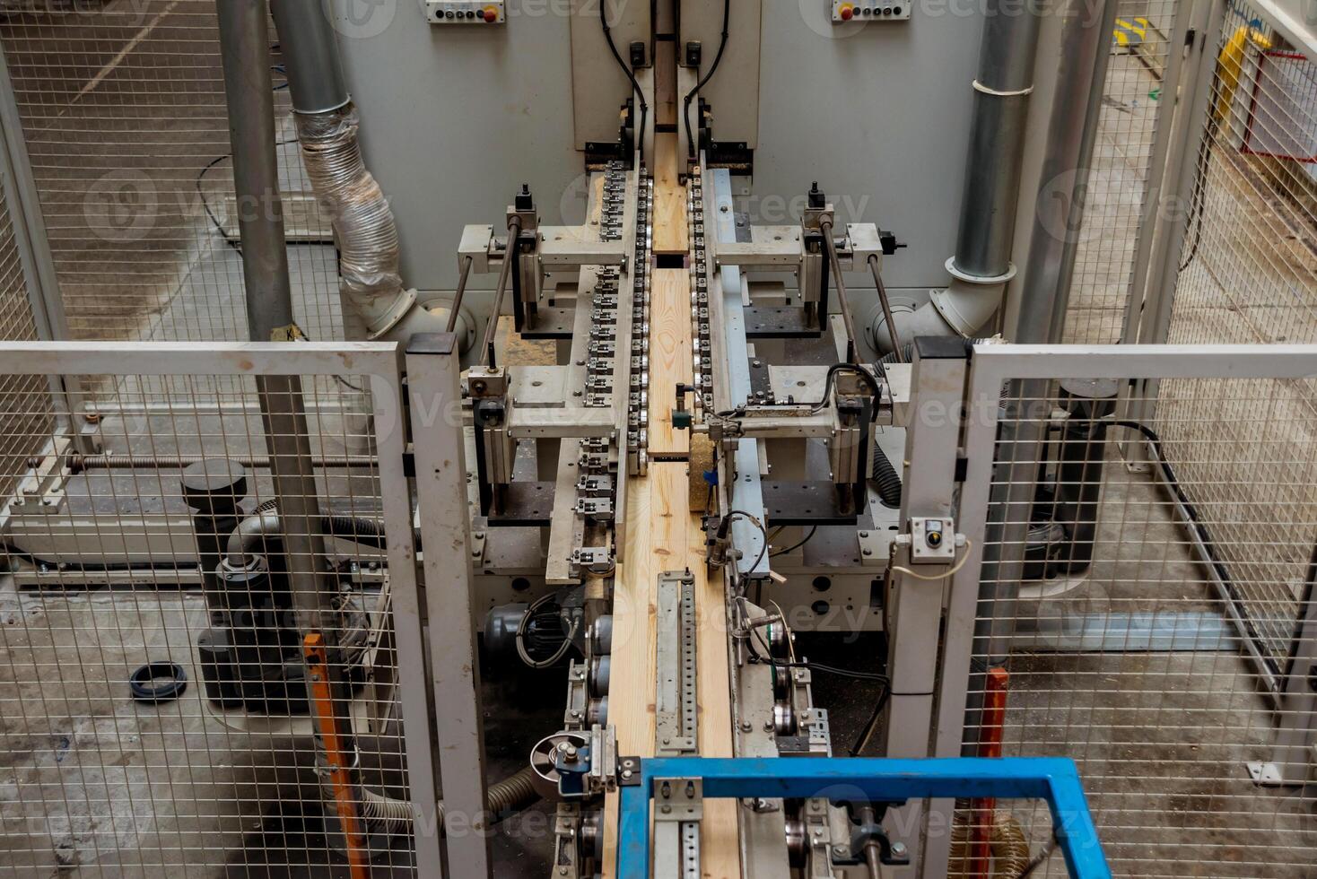 Production line of the wooden floor factory. CNC automatic woodworking machine. photo