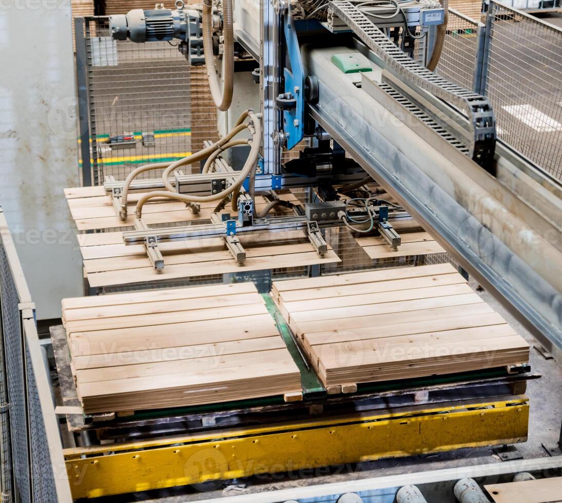 Production line of the wooden floor factory. CNC automatic woodworking machine. photo