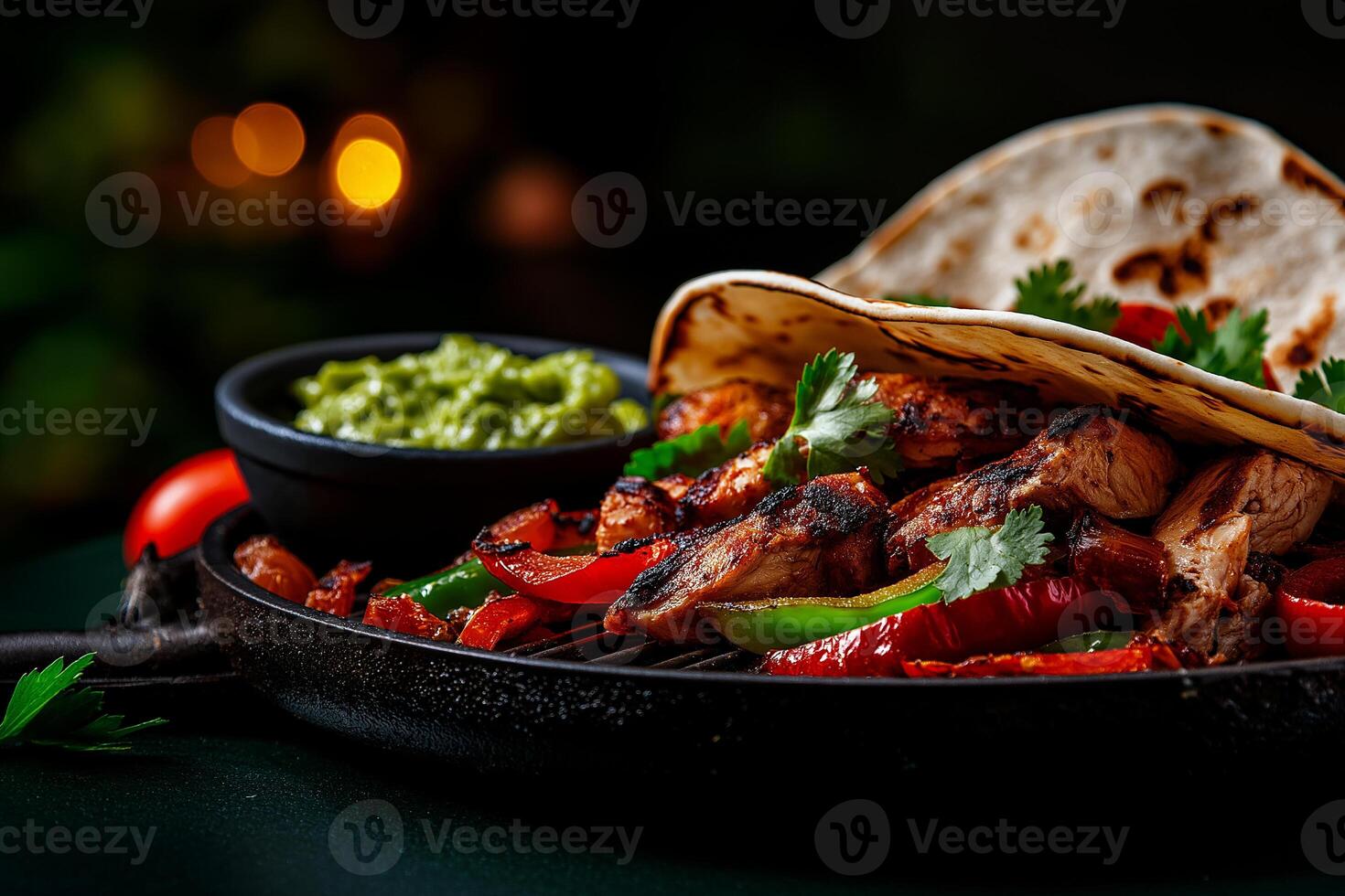 Delicious chicken fajitas with colorful peppers and onions served on hot grill, accompanied by fresh guacamole and warm tortillas, creating vibrant and appetizing meal photo