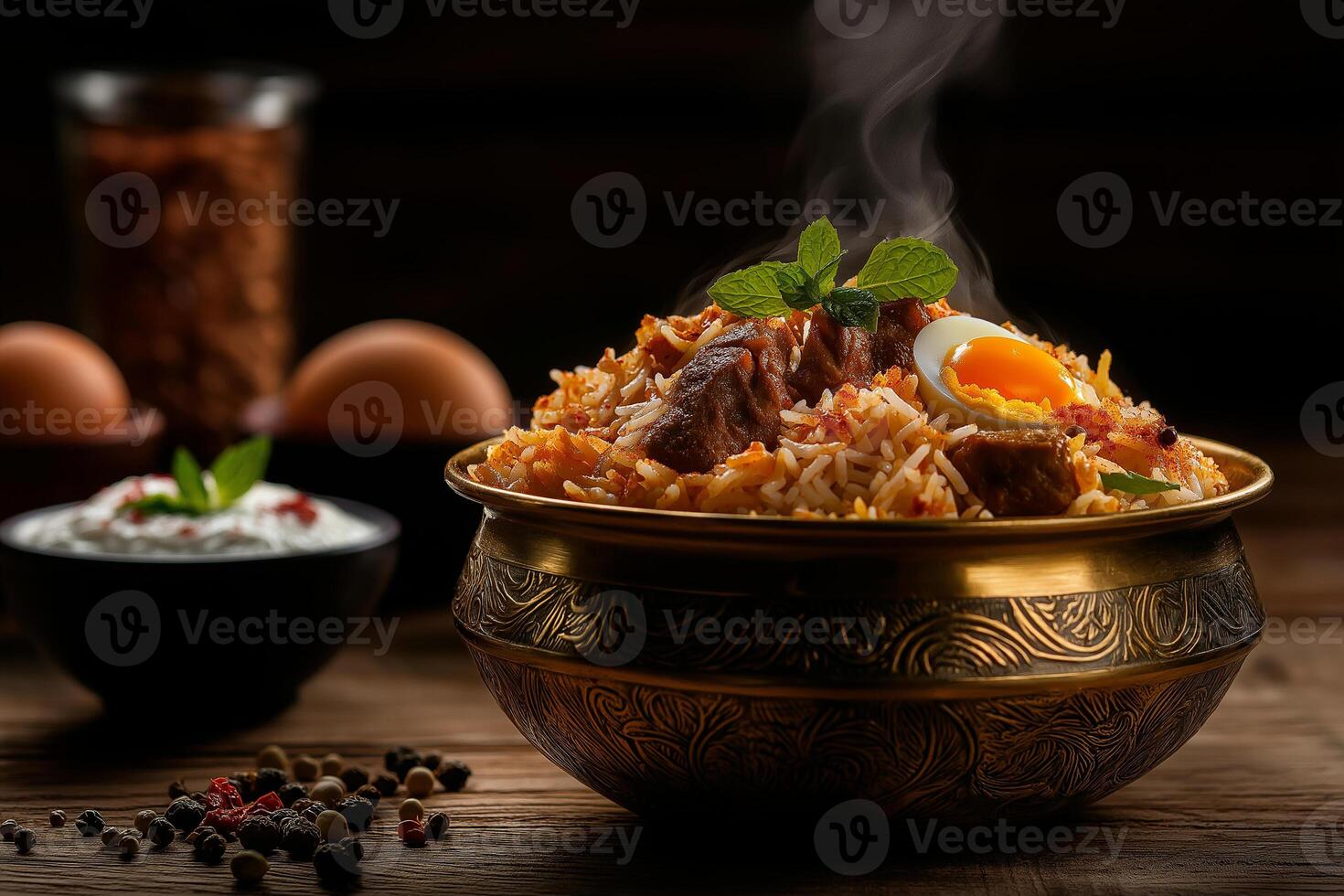 Aromatic chicken biryani with eggs, garnished with mint leaves, served in traditional bowl. dish is steaming, showcasing its rich flavors and spices photo