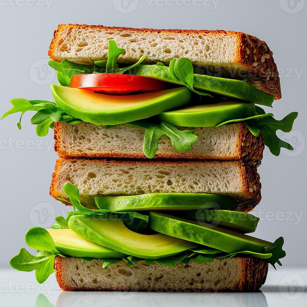 stack of whole grain sandwiches filled with fresh avocado, tomato, and leafy greens, showcasing healthy and vibrant meal option photo