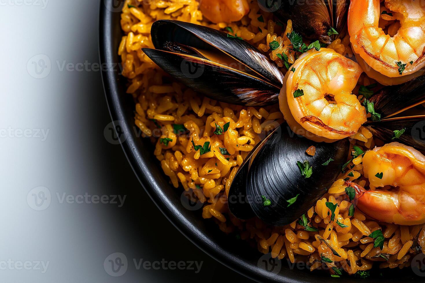 Saffron rice with mussels and shrimp in black bowl, garnished with parsley, creates vibrant and appetizing dish. rich colors and textures evoke sense of culinary delight photo