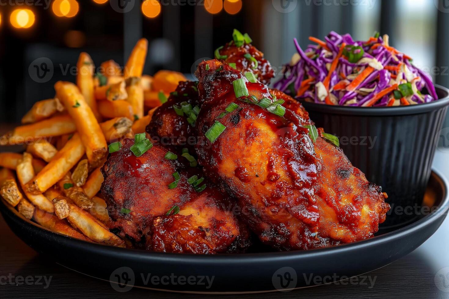 plate of hot and spicy fried chicken with coleslaw and sweet potato fries, garnished with green onions, creating delicious and appetizing meal photo