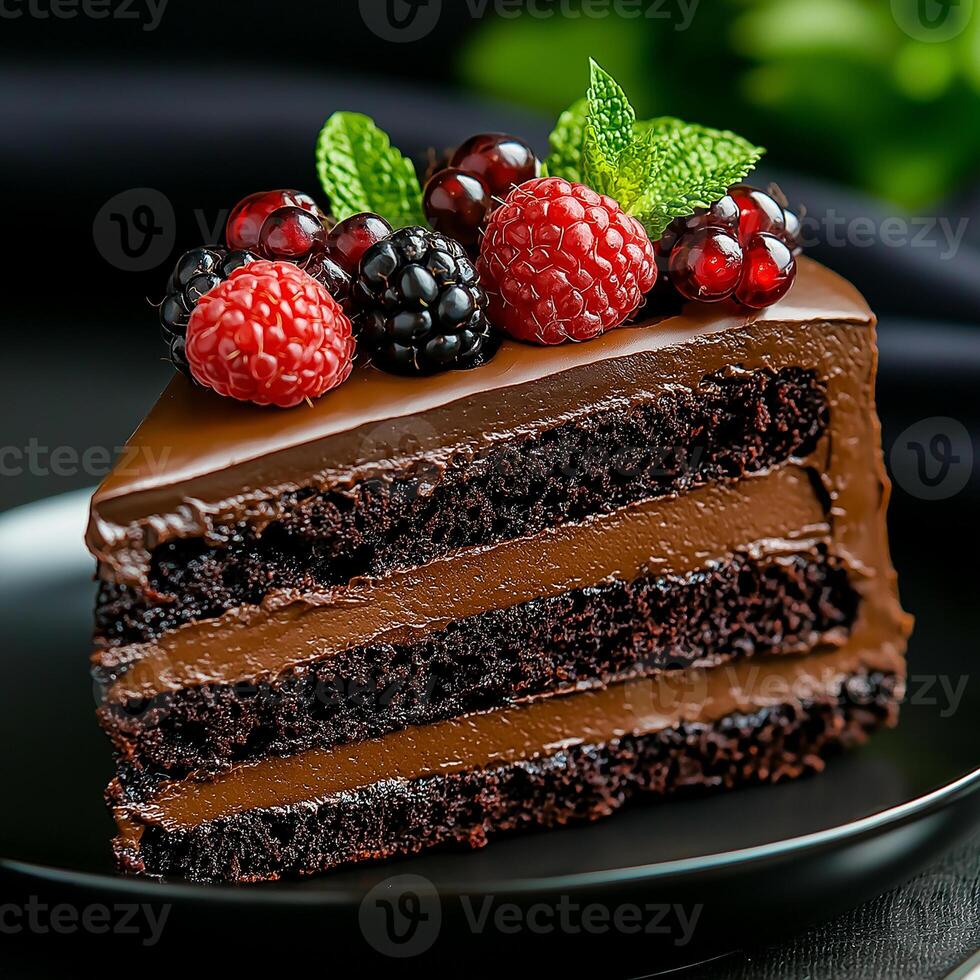 delicious slice of chocolate cake layered with rich frosting and topped with fresh berries, including raspberries, blackberries, and red currants, evokes sense of indulgence and delight photo