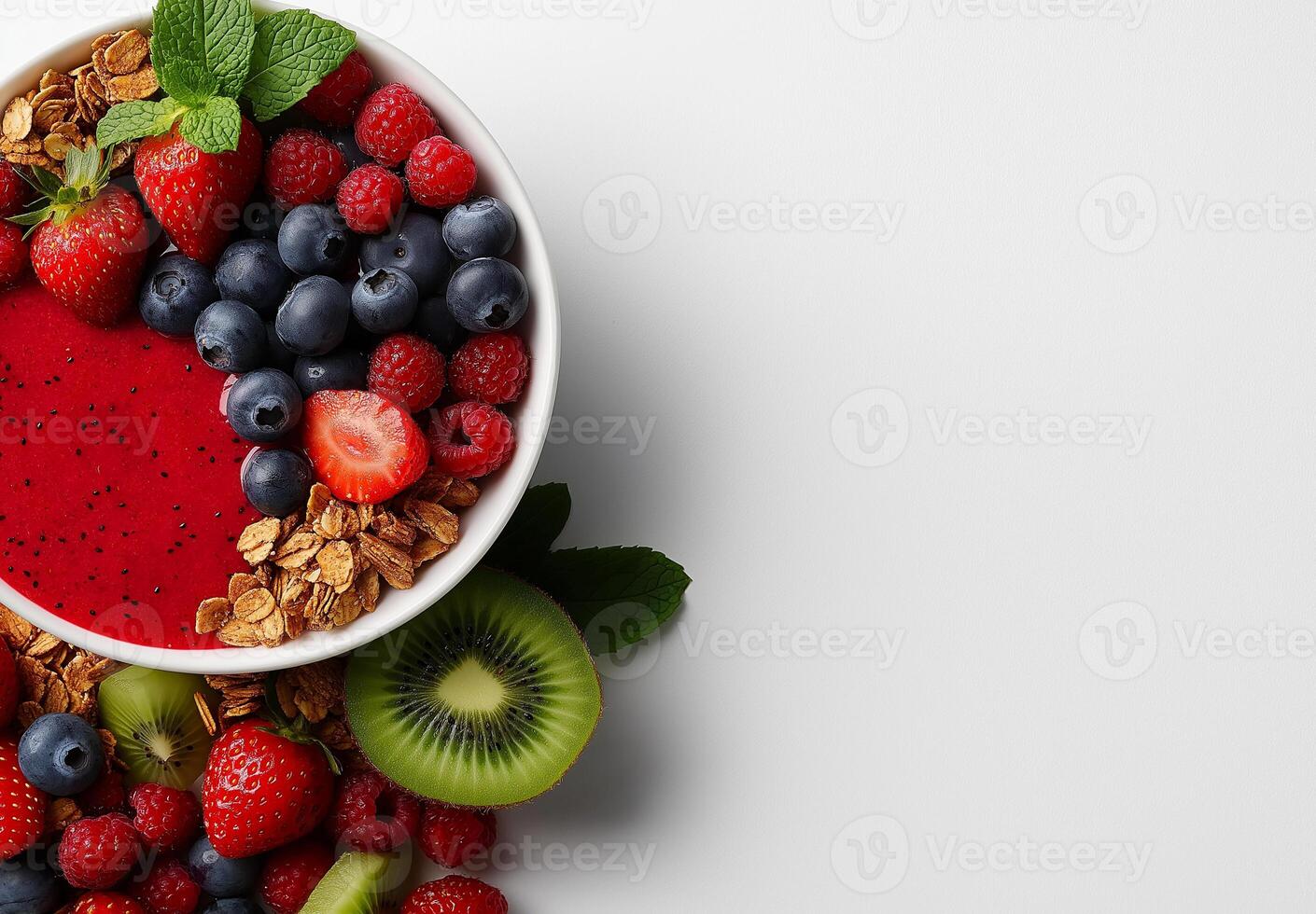 vibrant smoothie bowl topped with fresh berries, granola, and mint. This colorful dish features strawberries, blueberries, raspberries, and kiwi, perfect for healthy breakfast or snack photo