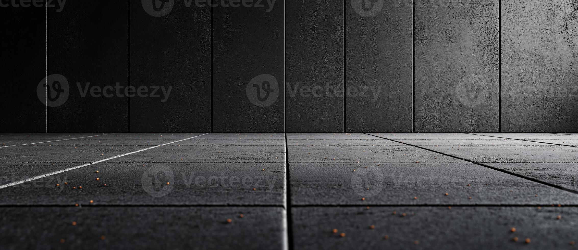 Empty concrete wall and asphalt floor create minimalist backdrop, showcasing modern industrial aesthetic. subtle texture and scattered debris add depth to scene photo
