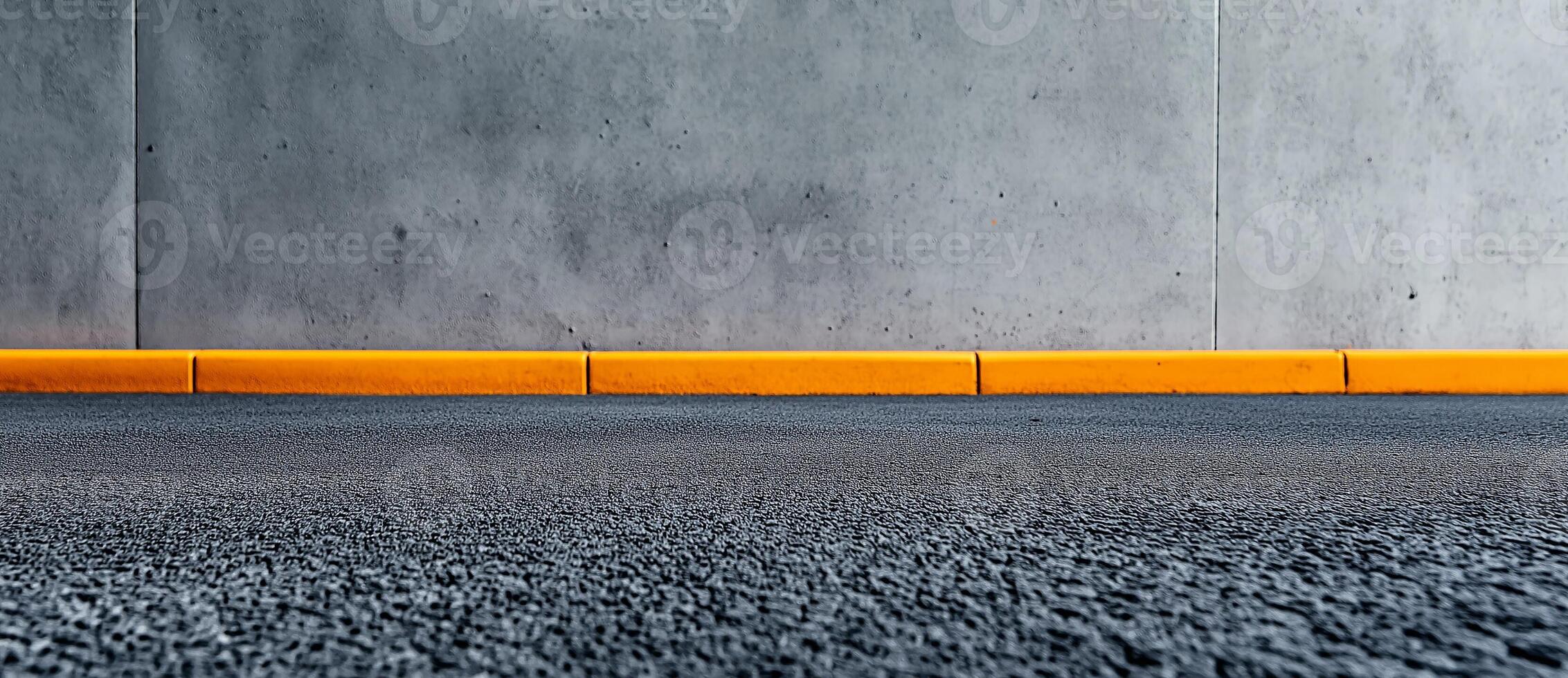 textured asphalt floor meets smooth concrete wall, featuring bright yellow curb. contrast creates modern urban aesthetic, ideal for various design projects photo