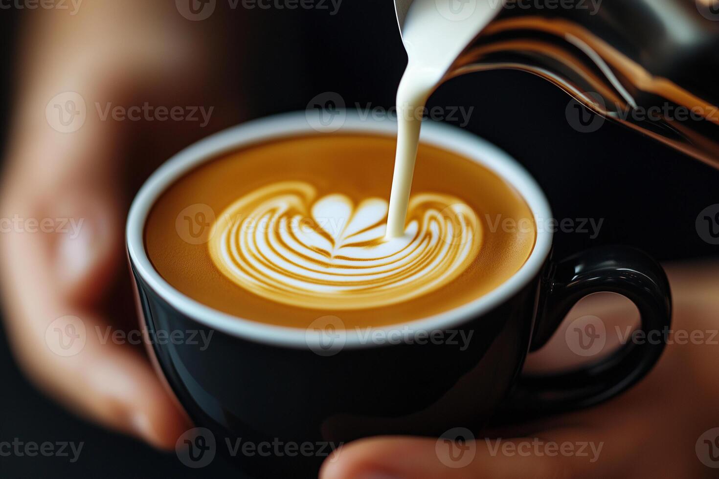 barista skillfully pours steamed milk into coffee cup, creating beautiful latte art design. warm tones of coffee contrast with black cup, evoking cozy atmosphere photo