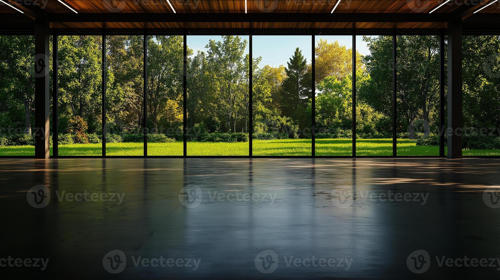 spacious empty room with large glass windows showcasing vibrant green landscape outside. natural light creates warm and inviting atmosphere, perfect for various uses photo