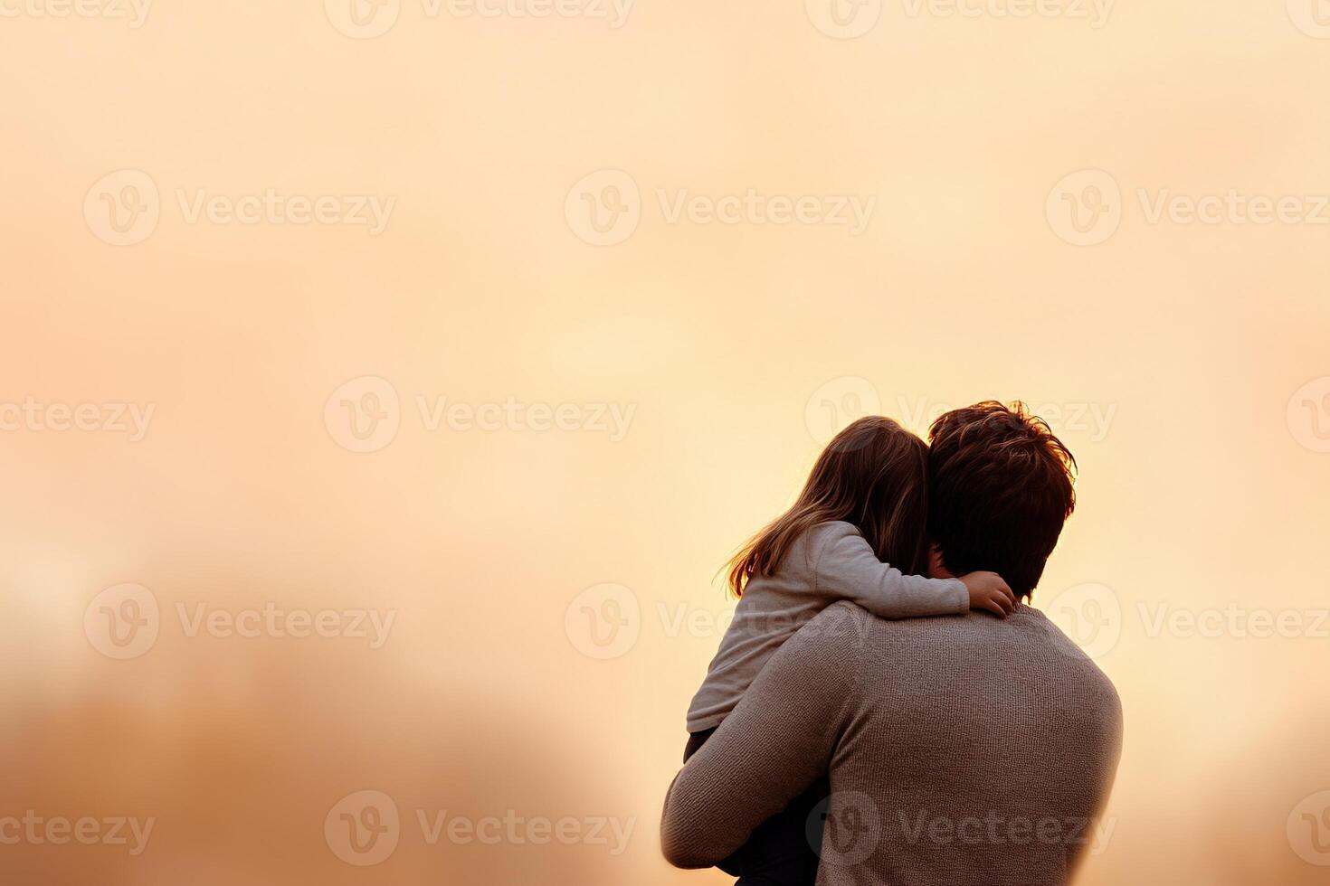Silhouette depicts a father tenderly holding his child during a breathtaking sunset. Soft warm hues envelop the scene, creating a serene and loving atmosphere in the twilight photo