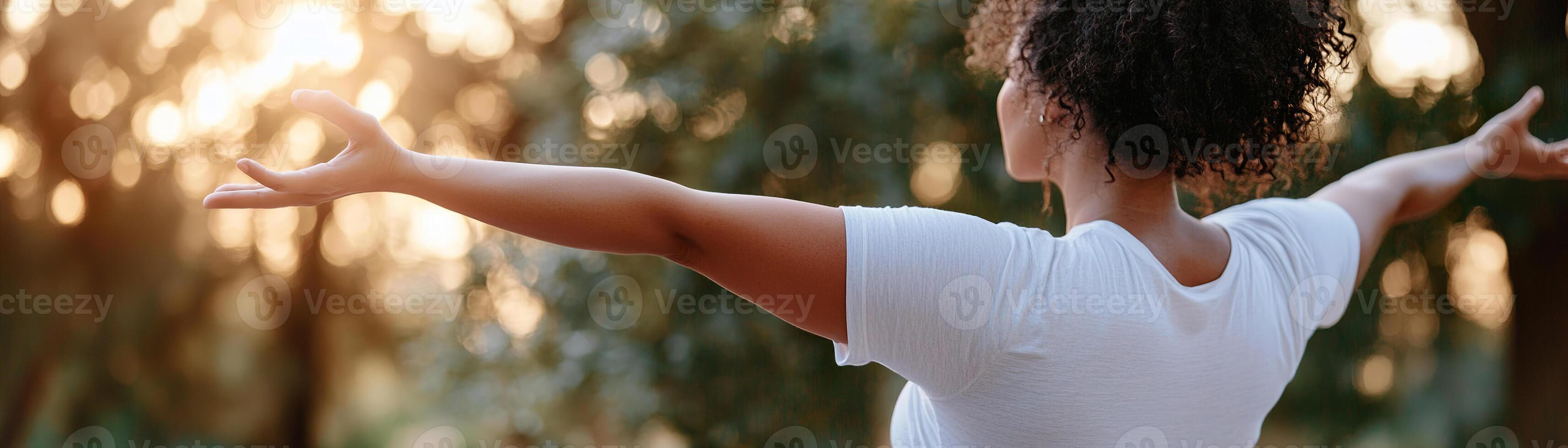 A confident plus-size yoga instructor guides a class in a serene outdoor setting. Soft light filters through greenery, creating a peaceful atmosphere that promotes wellness and empowerment photo