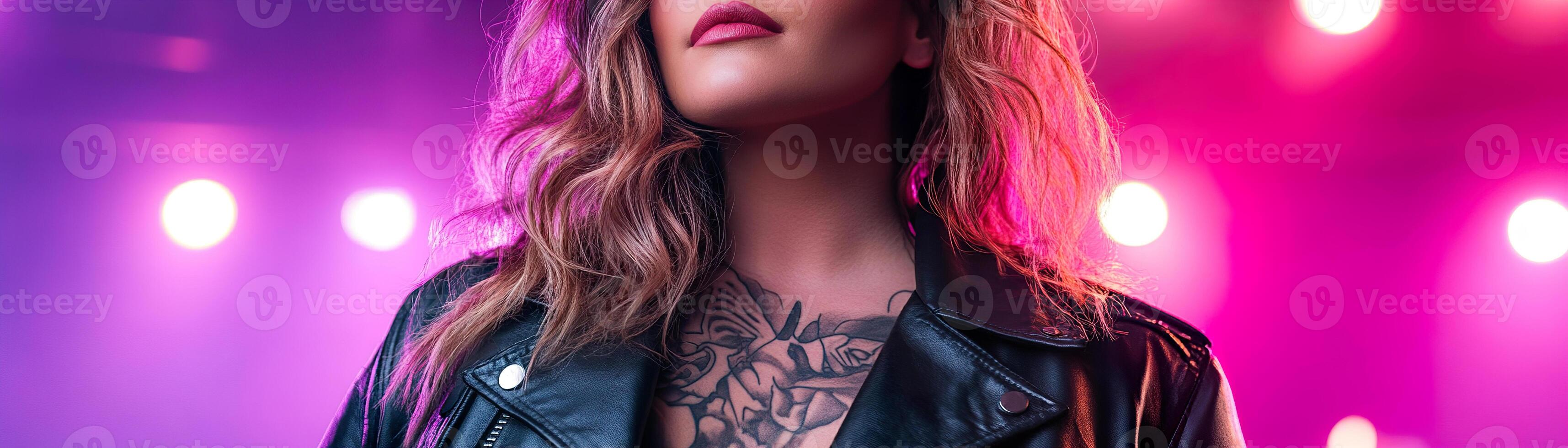 A confident plus-size woman with detailed tattoos stands at a vibrant rock concert, illuminated by soft neon lights. Her black leather jacket adds to the high-energy atmosphere of the night photo
