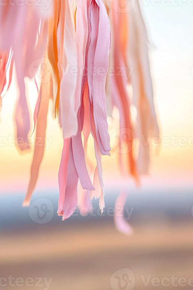 Colorful streamers dangle in the foreground, capturing the essence of a lively carnival amidst a warm pink and orange sunset sky, ideal for festive celebrations and events photo