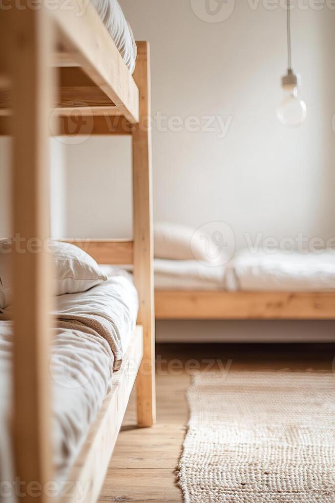 Two bunk beds with mismatched bedding fill a small shared hostel room. A single lightbulb hangs overhead, illuminating the well-worn rug on wooden floors, capturing a relaxed travel atmosphere photo