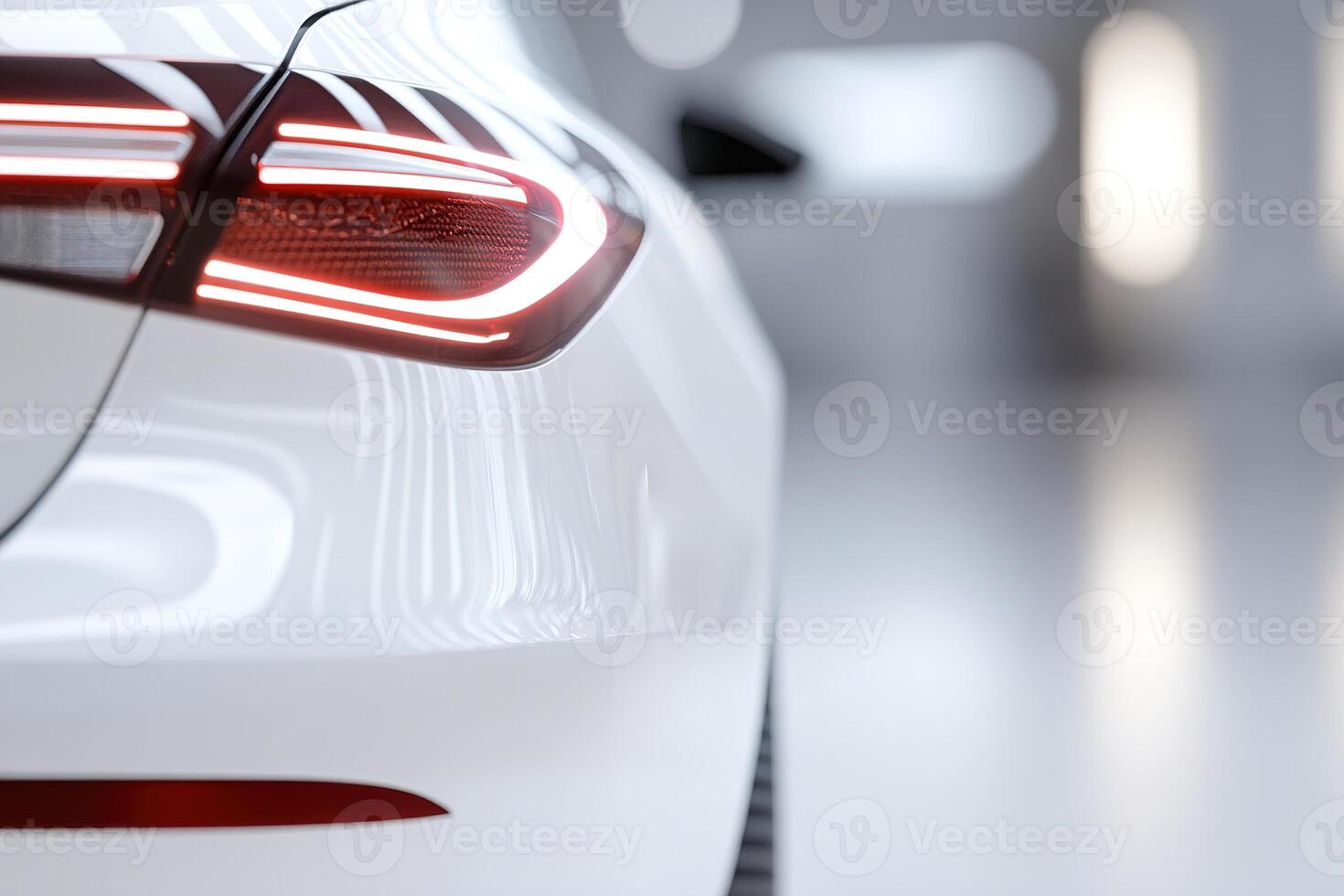 A close-up view of a sleek white car reveals its glowing tail light, set against a clean, modern interior with soft lighting highlighting the curves photo
