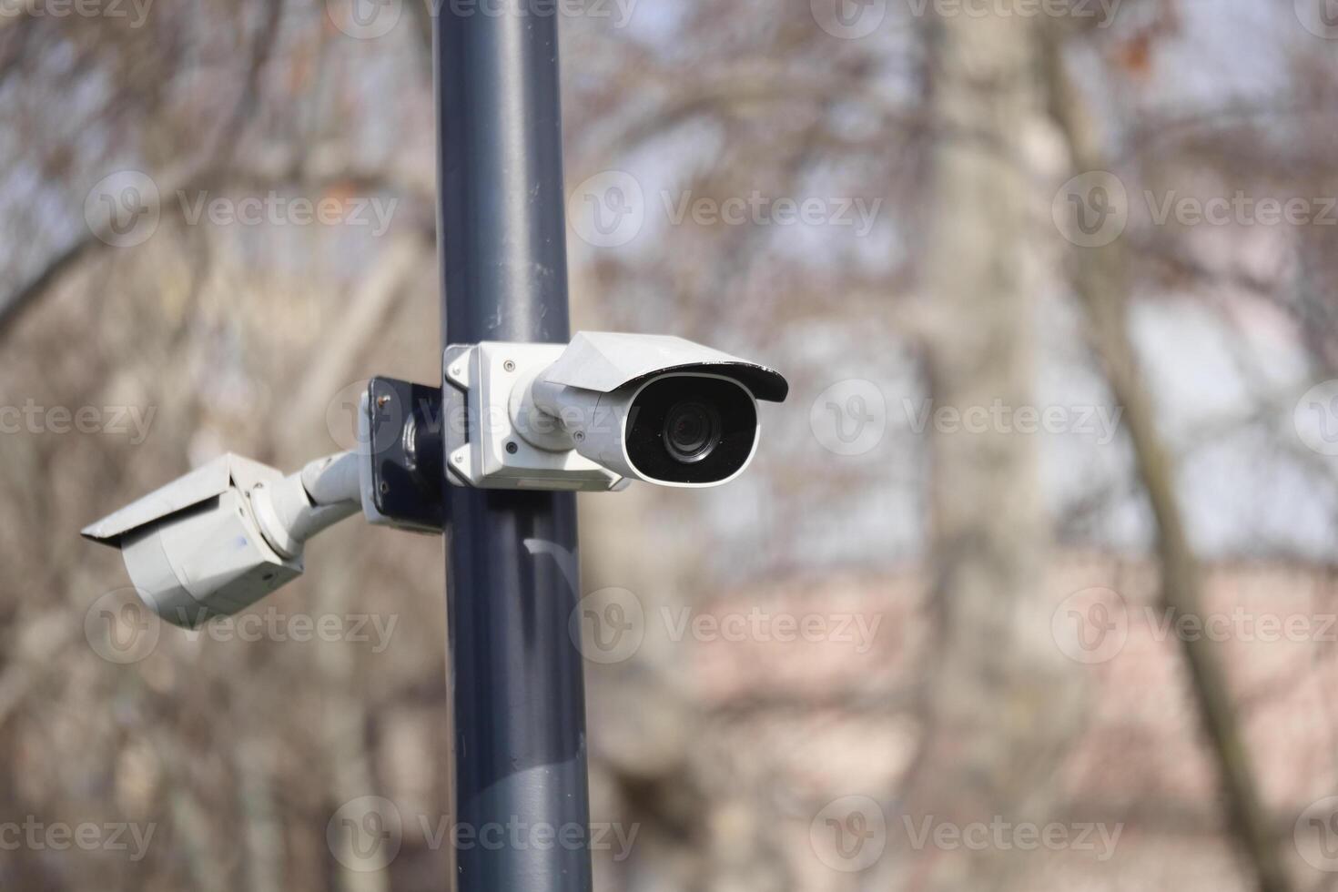 Security cameras mounted on a pole in an urban setting photo