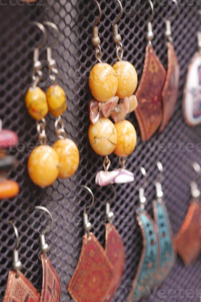 Unique handmade earrings displayed at a local market stand photo