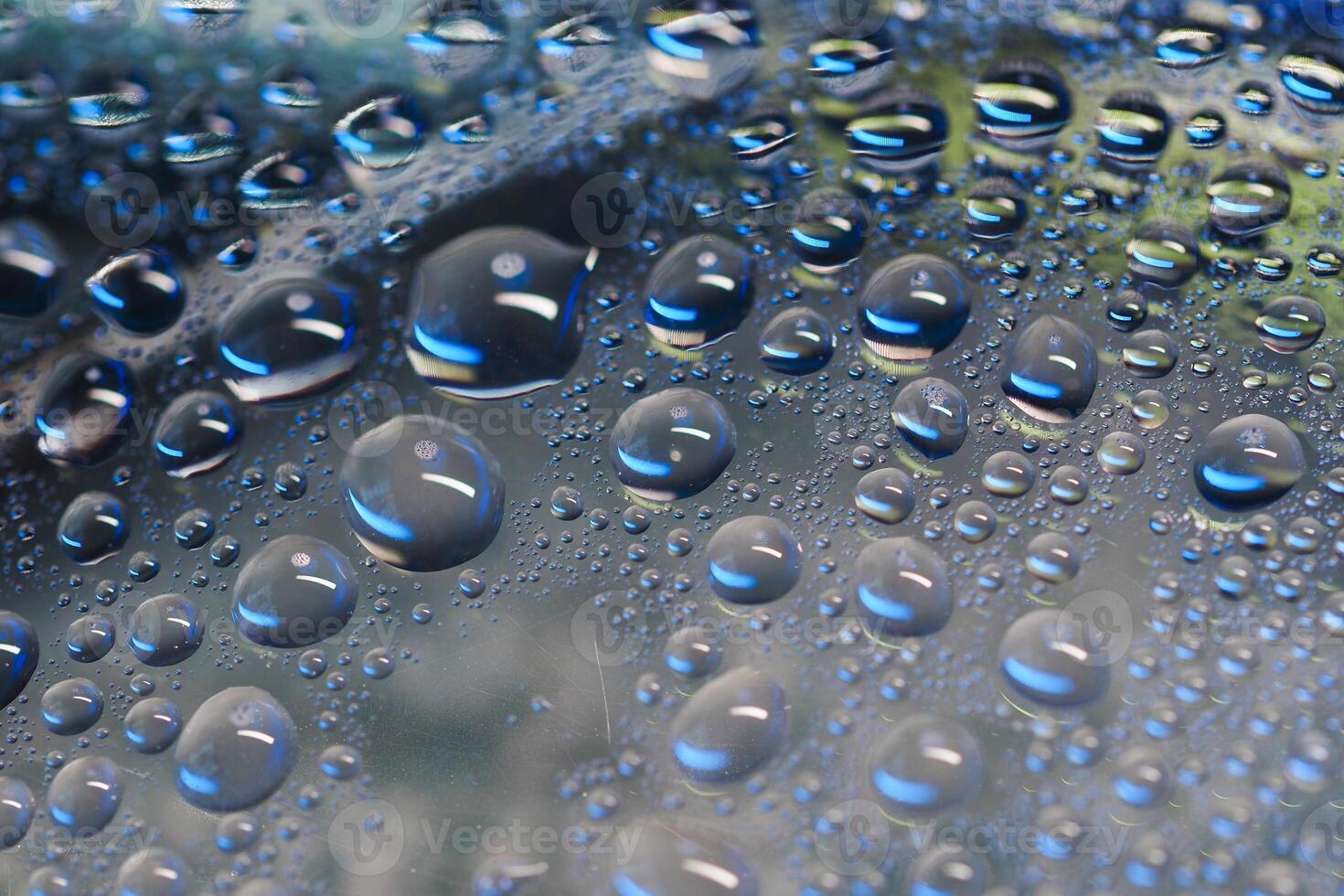 Close-up view of water droplets on a blue surface photo