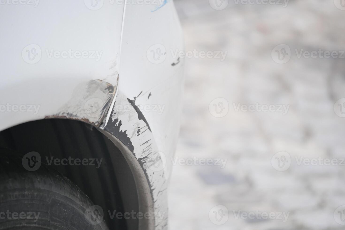 Car damage on the side near asphalt road in bright daylight photo