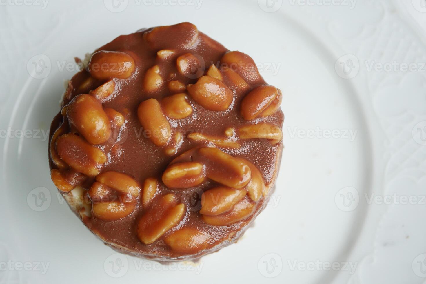 Delicious dessert featuring peanuts and caramel topping on a plate photo