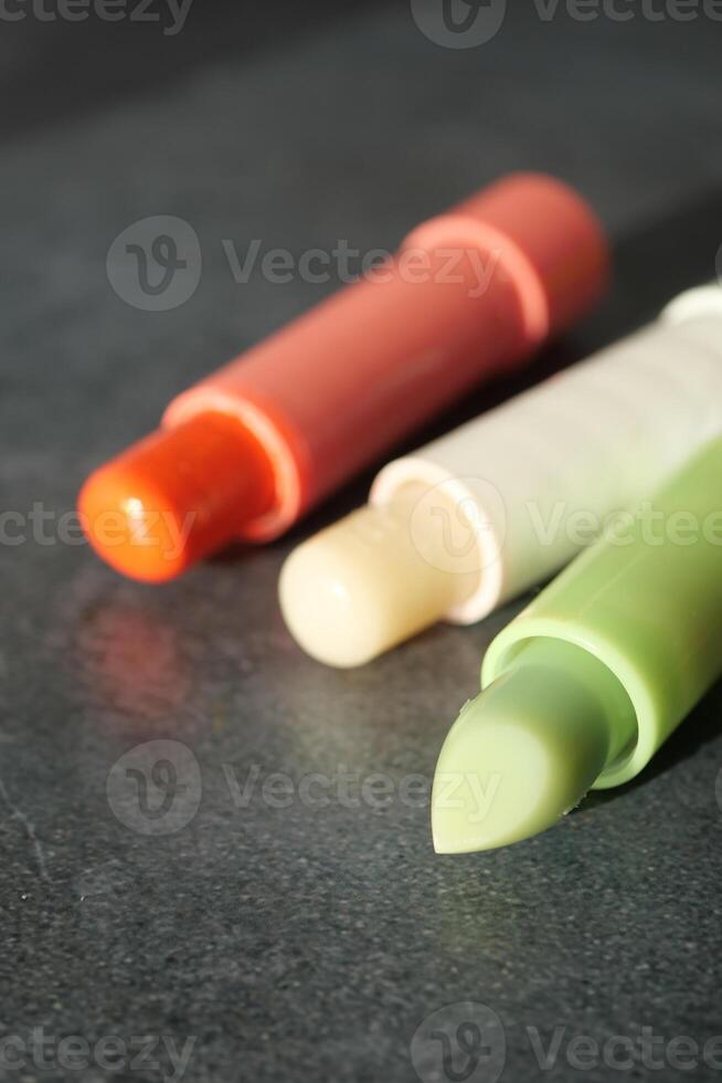 colorful lip bum on a table photo