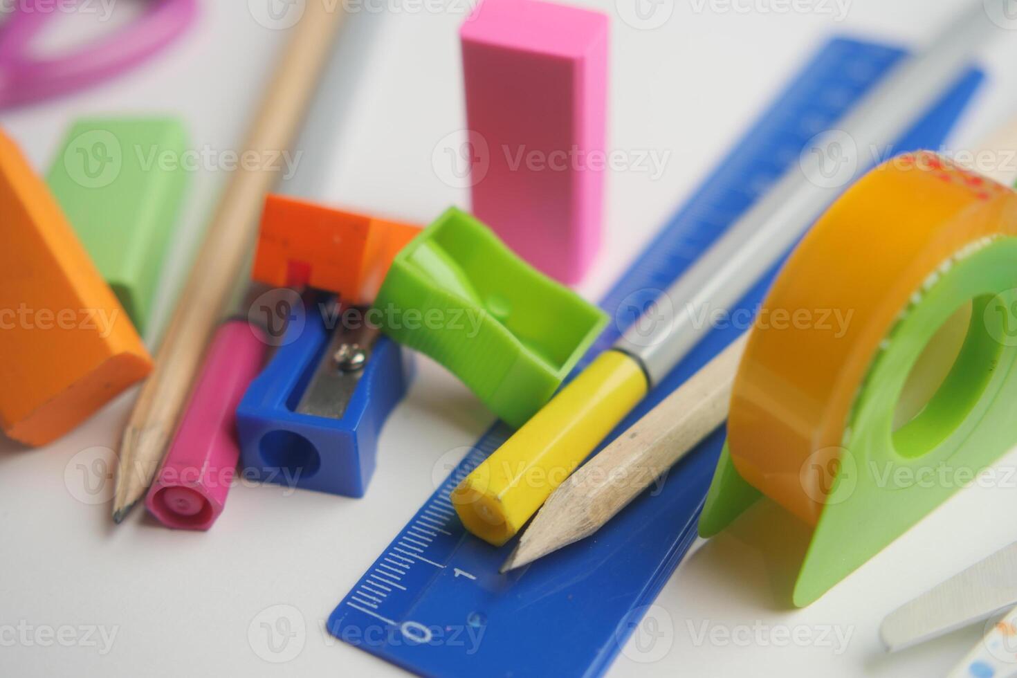 Colorful school supplies arranged on a white surface photo