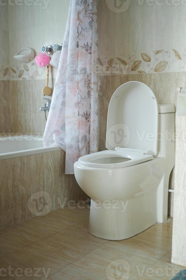 Clean bathroom with modern toilet and bathtub design in soft colors photo