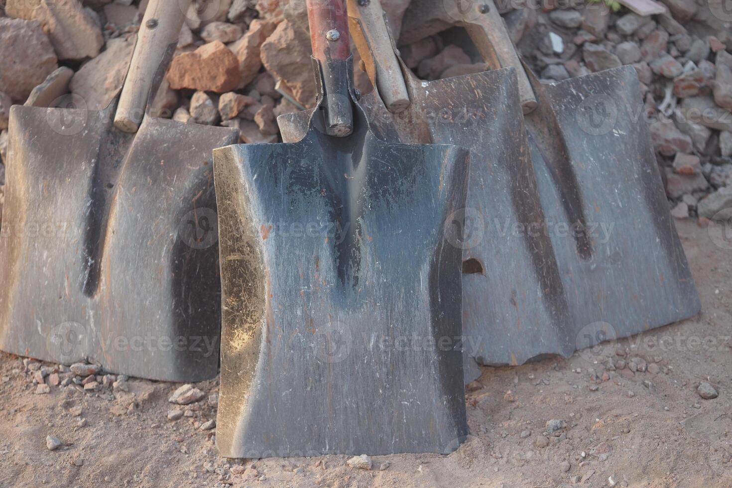 Various shovels displayed on the ground in a construction area photo
