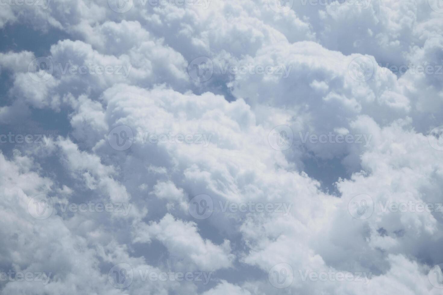 Bright white clouds fill the sky on a sunny day in summer photo