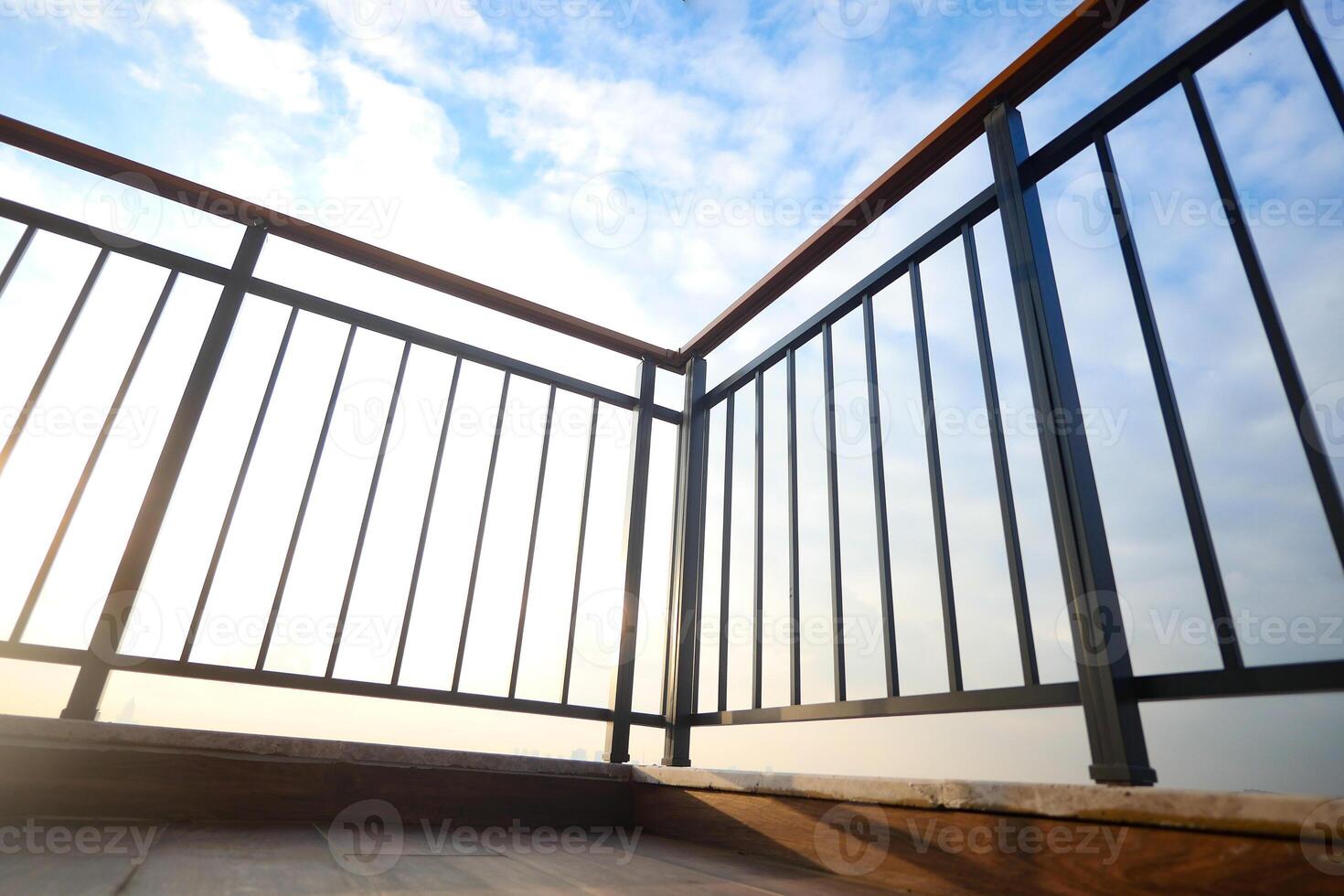 Balcony view overlooking a bright sky at sunrise time photo