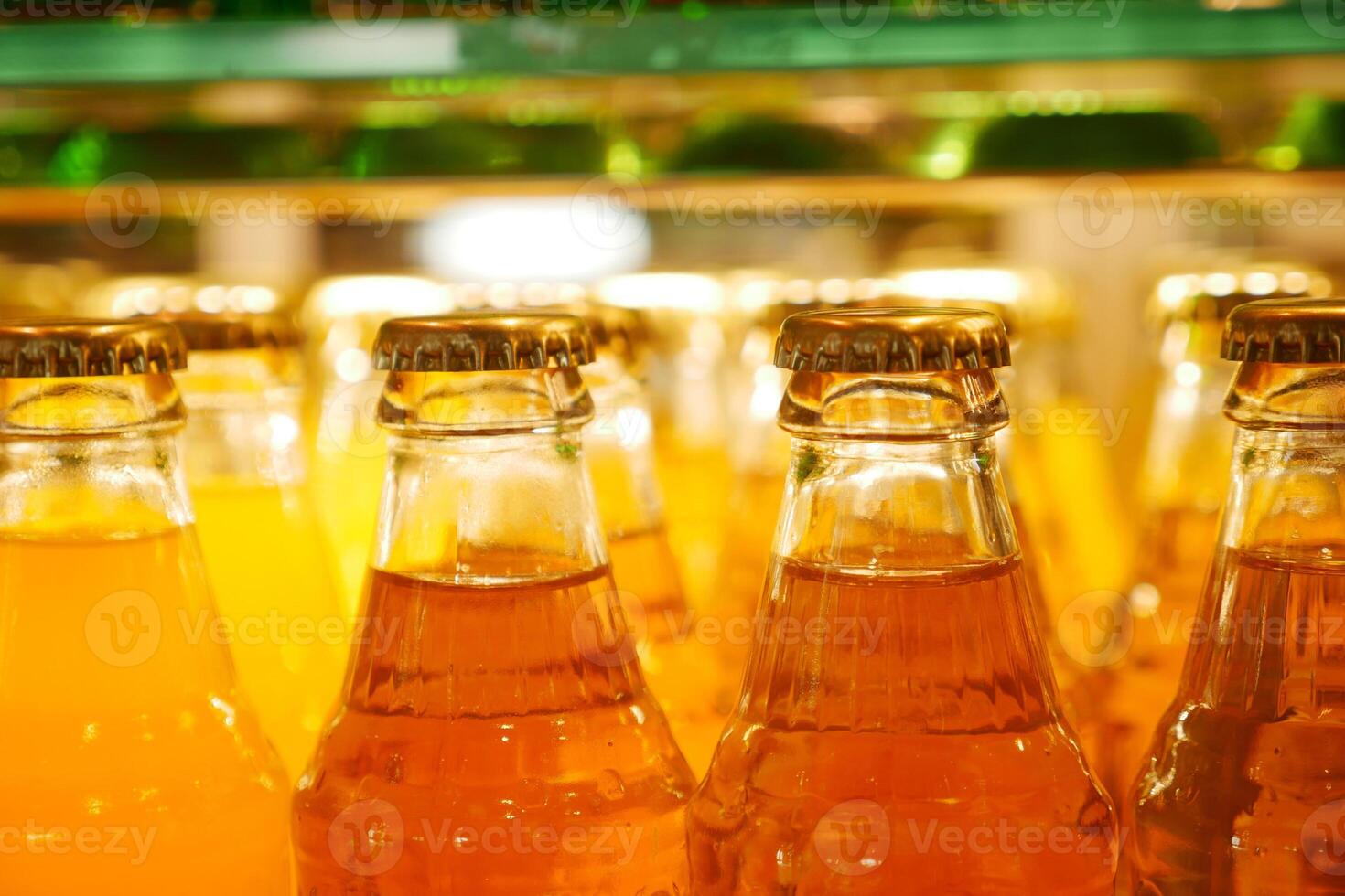 Bottles of colorful beverages displayed in a bright shop photo
