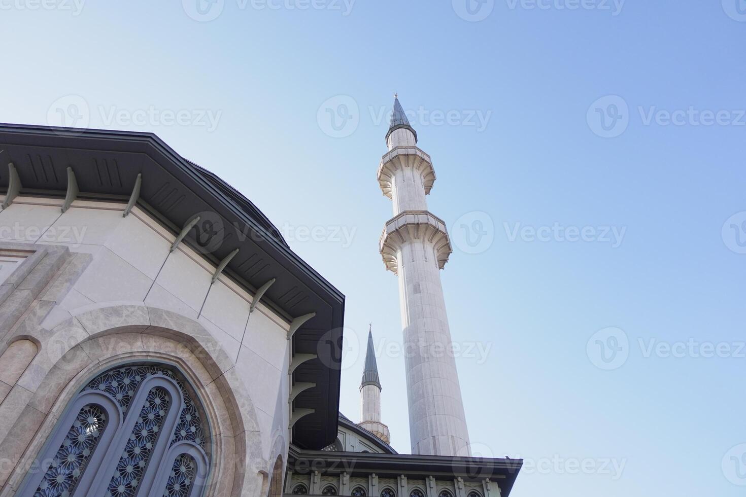 Intricate architecture of a mosque under a clear blue sky photo