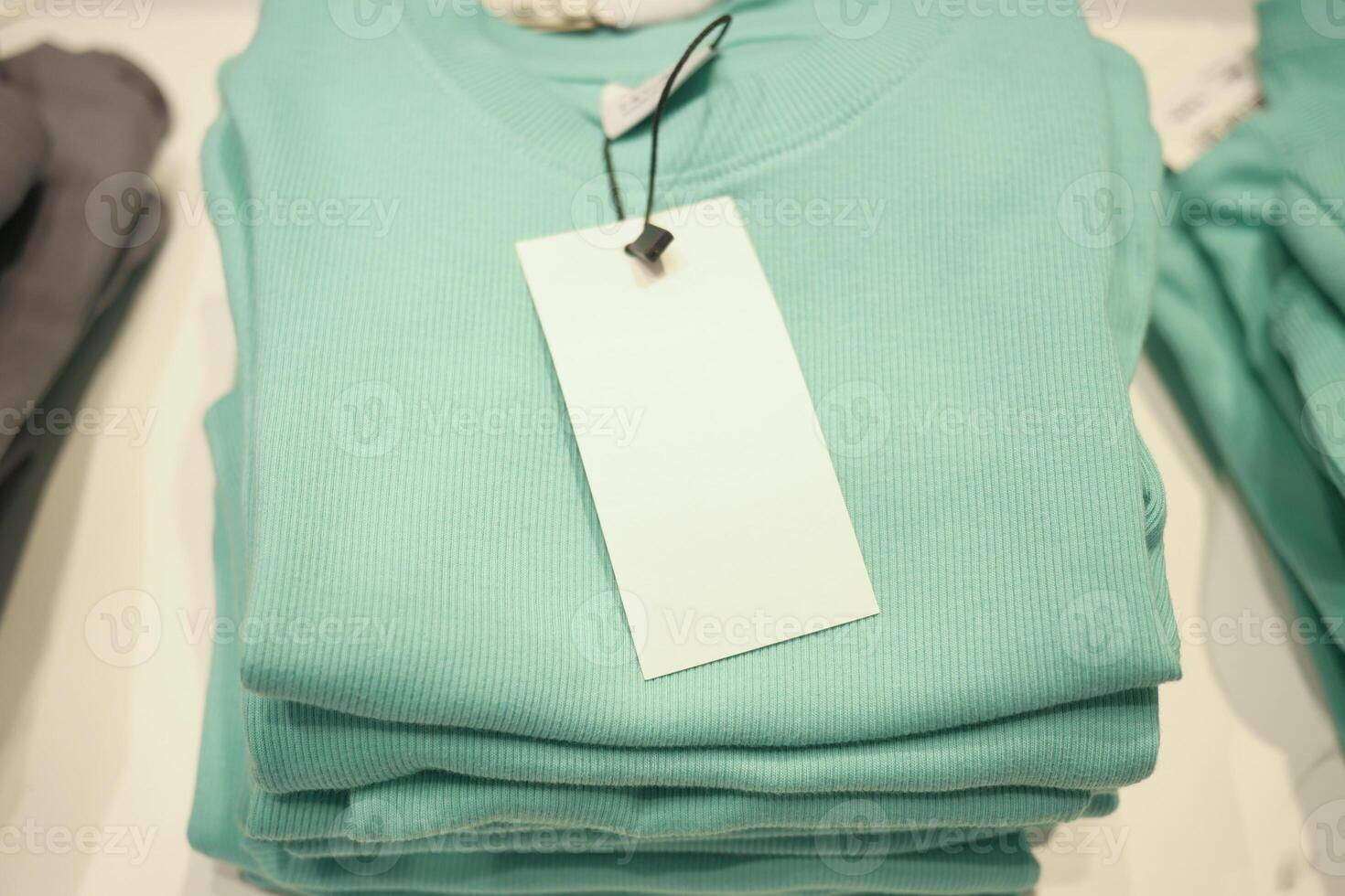 Soft mint green sweaters arranged neatly on display for customers photo