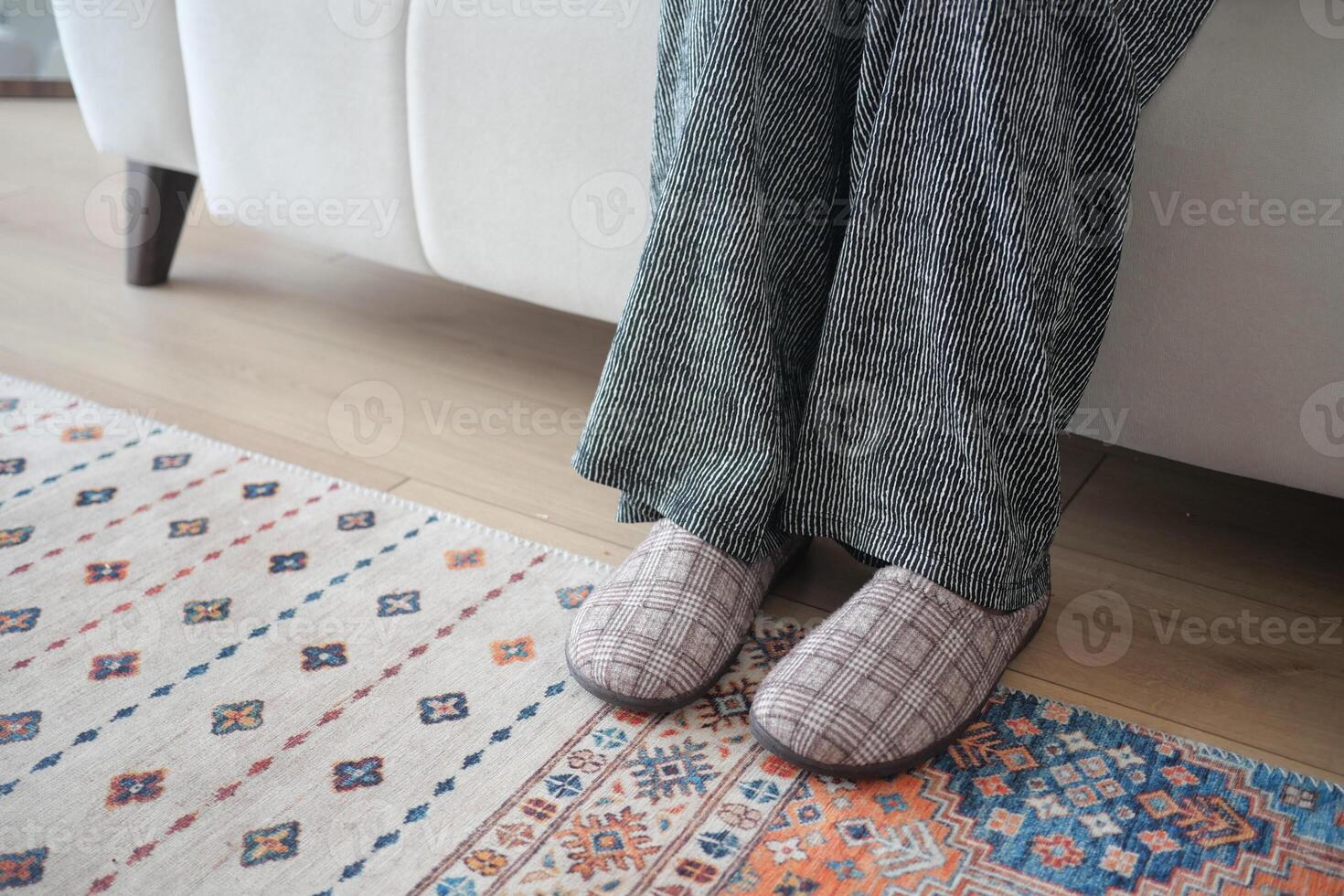 Cozy indoor setup with relaxed feet on a soft rug photo